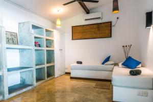 a living room with a couch and a window at Moi Talpe by DBI in Talpe
