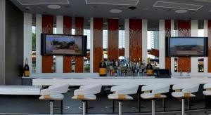 a bar with white chairs and a counter with bottles of wine at Luxury Suites International by Vdara in Las Vegas +63 photos