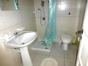 a bathroom with a shower and a sink and a toilet at Verde in Santa Margherita di Pula
