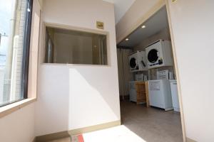 a hallway of a kitchen with a window at Hotel Migrant - Vacation STAY 81252v in Tateyama