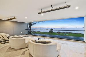 a living room with a view of the ocean at Breach House Rhyll in Rhyll