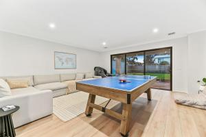 a living room with a ping pong table at Breach House Rhyll in Rhyll