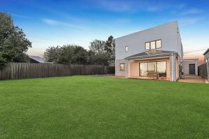 a house with a lawn in front of it at Breach House Rhyll in Rhyll