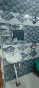 a bathroom with a white sink and a mirror at NG Hotal near by Prem mandir in Vrindāvan