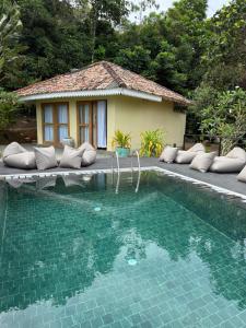a swimming pool in front of a house at Villa Hillcrest in Weligama