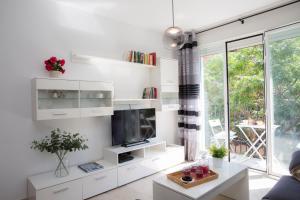 a living room with white shelves and a tv at SingularStays Na Jordana in Valencia