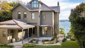 a house with a view of the water at Kutti Beach House in Sydney