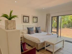 a bedroom with a bed and a potted plant at Amoris Guesthouse - Waterkloof ridge in Pretoria +35 photos