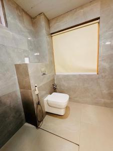 a bathroom with a toilet and a window at Yeasel Continental Gangtok in Gangtok +28 photos