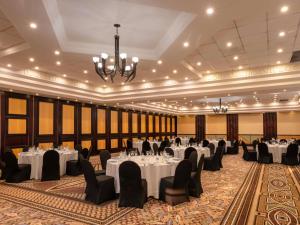 a banquet hall with tables and chairs and a chandelier at Mövenpick Hotel Windhoek in Windhoek +131 photos