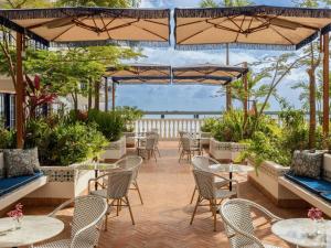 a patio with tables and chairs and umbrellas at Sofitel Legend Casco Viejo, Panama City in Panama City +237 photos