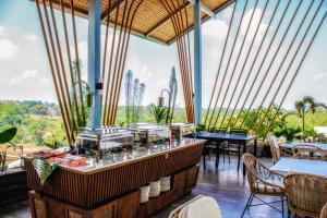 a restaurant with a large window with tables and chairs at FarmKO Glamping in Dolores