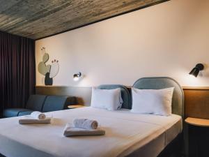 a hotel room with a bed with towels on it at ibis Styles ST Pauls Bay Malta in St. Paul's Bay