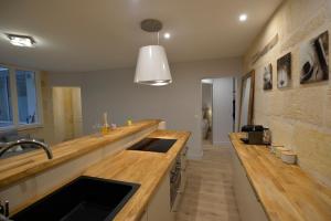 a kitchen with wooden counter tops and a sink at Esprit Bordelais in Bordeaux