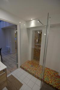 a shower with a glass door in a room at Esprit Bordelais in Bordeaux