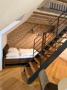a bedroom with a bed and a brick wall at Ultimate Group Getaway - Three of Everything! in Bratislava