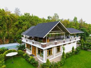 an aerial view of a white house with a black roof at Megha Resort & Villas, Dehradun-Where Nature Pampers You in Dehradun