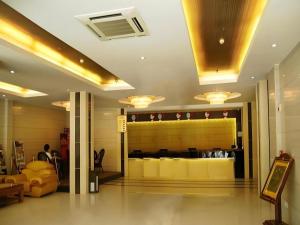 a lobby of a restaurant with a yellow counter at Guo Bin Hotel in Danjiangkou