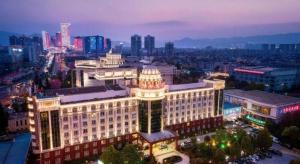 a large building is lit up at night at Kunming Noah's Ark Hotel in Kunming