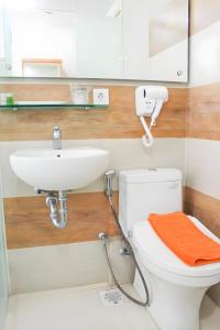 a bathroom with a white toilet and a sink at An Hotel Jakarta in Jakarta