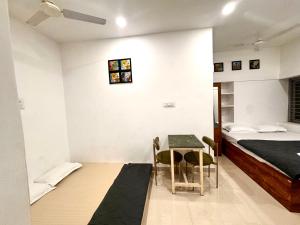 a bedroom with a bed and a table and a desk at Vibes stay in 5 in Hyderabad