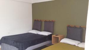 a small bedroom with a bed and a table at Finca El Turpial in Alcalá +8 photos