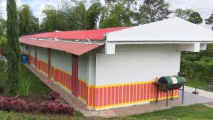 a small house with a red roof at Finca El Turpial in Alcalá
