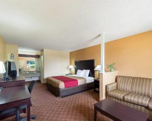 a hotel room with a bed and a couch at Econo Lodge Inn & Suites San Antonio near Frost Bank Center in San Antonio