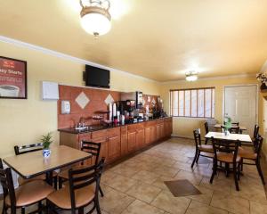 a restaurant with tables and chairs and a kitchen at Econo Lodge Inn & Suites San Antonio near Frost Bank Center in San Antonio