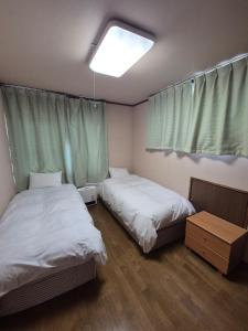 Postel nebo postele na pokoji v ubytování Hakuba Holiday Home