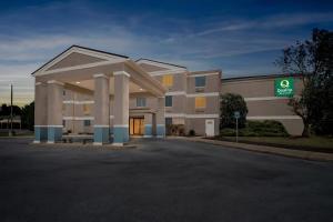 a large building with a parking lot in front of it at Quality Inn Shepherdstown in Shepherdstown