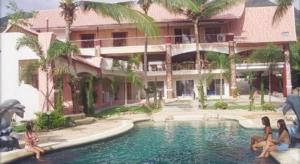 un gruppo di persone sedute in una piscina di fronte a un edificio di Plaloma Cliff Resort a Ko Chang
