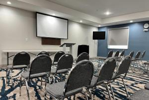 a conference room with chairs and a screen at Comfort Suites Oil Center in Lafayette +44 photos