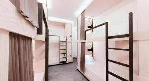 a room with two bunk beds and a ladder at Capsule@Hive Bugis in Singapore +92 photos