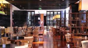 a dining room with tables and chairs and a library at Ramada by Wyndham Zhengzhou East in Zhengzhou