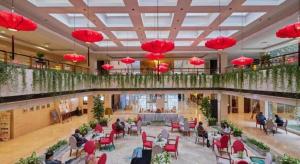 a lobby with people sitting in chairs in a building at Huangshan International Hotel in Huangshan
