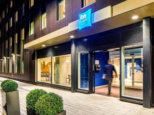 a man walking outside of a building at ibis budget Manchester Airport T2 in Hale +72 photos