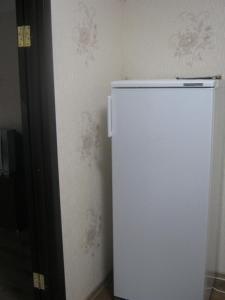 a white refrigerator in the corner of a room at Apartment in Pyatigorsk in Pyatigorsk