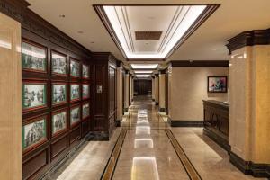 a hallway of a building with pictures on the walls at Jin Jiang Nanjing Hotel in Nanjing
