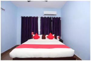 a bedroom with a large bed with red pillows at Hotel Moonlight Palace Near Patia Railway Station-Fully Air Conditioning Hotel - Luxury & Spacious Room -A Premium Hotel in Cuttack