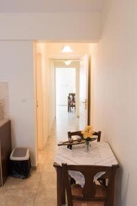 a dining room with a table and a hallway at Vrokastro Apartments in Istro