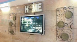 a flat screen tv hanging on a wall at Metro Winner Hotel in Hong Kong +112 photos
