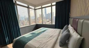 a bedroom with a bed with a large window at Metro Winner Hotel in Hong Kong