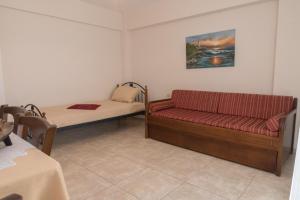 a small room with a bed and a couch at Vrokastro Apartments in Istro