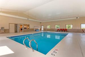 a large swimming pool with blue water in a building at Sleep Inn & Suites Wisconsin Dells - Lake Delton in Wisconsin Dells