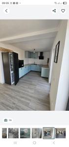 a kitchen with blue cabinets and a black refrigerator at ZenHome in Craiova