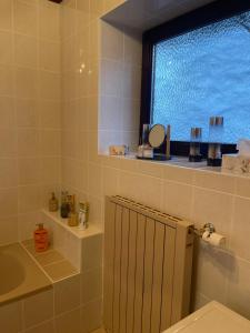 a bathroom with a window and a toilet and a sink at Apartment an der Mühle in Mühldorf +19 photos