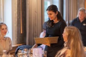 a woman holding a basket in a room with people at Hestraviken Hotell & Spa in Hestra +178 photos