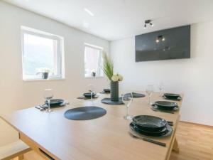 a dining room table with plates and wine glasses at Nature Beauty with pool and whirlpool in Zagvozd