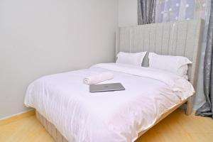 a laptop computer sitting on top of a bed at gilgalhomes in Gatunga